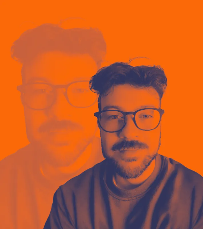 Man with glasses and beard against orange double-exposure backdrop