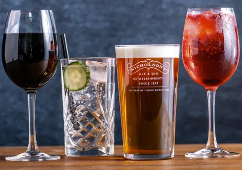 Red wine, gin with cucumber, pale ale, and spritz lined up on bar counter